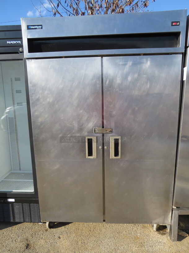 One Stainless Steel Delfield 2 Door Freezer On Casters. 50.5X30X79.5