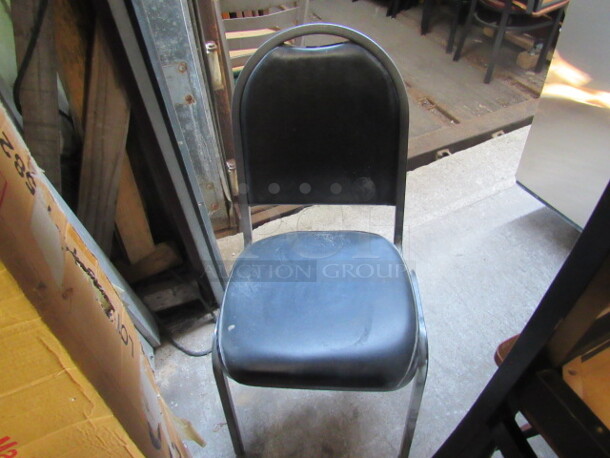 Metal Stack Chair With Black Cushioned Seat And Back. 4XBID