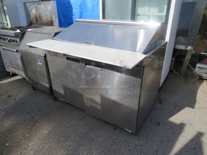 One Delfield 2 Door Refrigerated Prep Table With 2 Racks, And Cutting Board, On Casters. Model# 4448N-18M. 115 Volt. 48X40X46