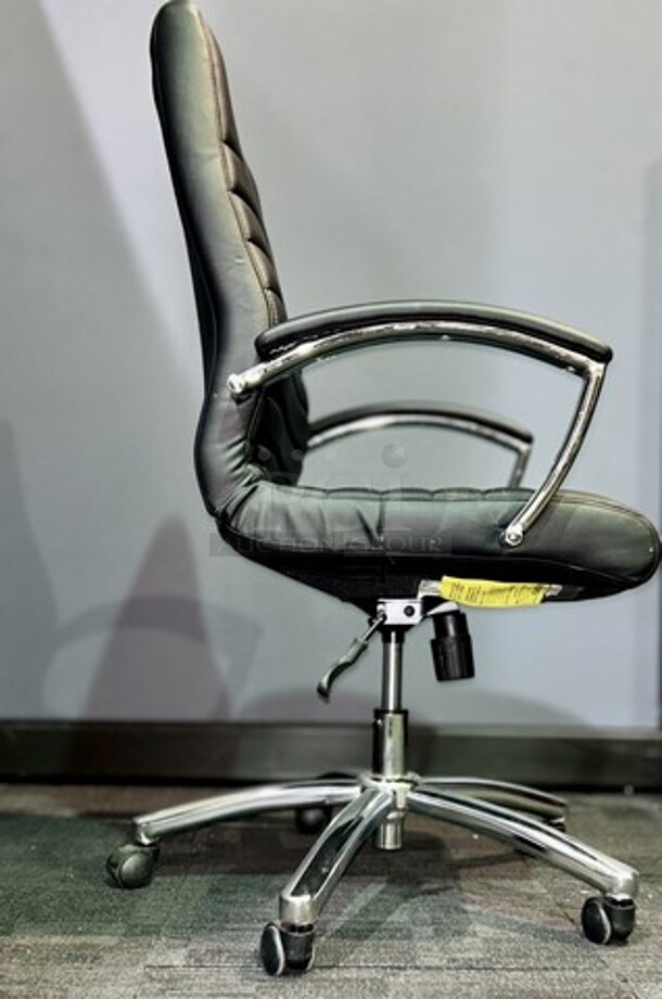 Item #60- Silver metal framed rolling office chair. Cushioned and ribbed black leather upholstery with armrests. A nice used piece! Measures 43” H x 22” W. 

 - Image 3 of 3