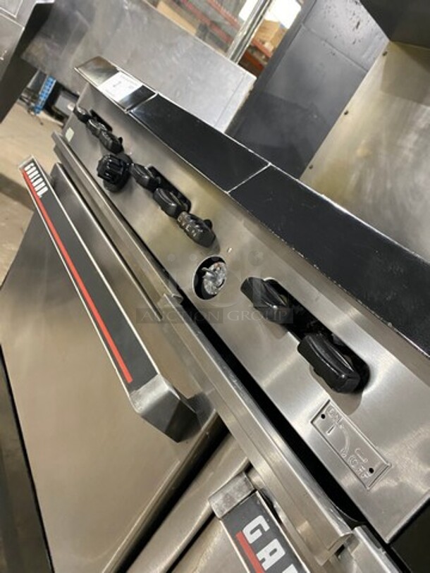 GREAT FIND! Garland Commercial Gas Powered 6 Burner Stove With Right Side Flat Griddle! Griddle Has Side Splashes! With Raised Back Splash And Salamander Shelf! With 2 Oven Underneath! Metal Oven Racks! All Stainless Steel! On Casters! Working When Removed! - Image 11 of 12