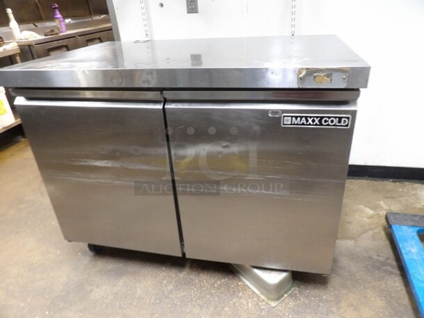 Maxx Cold, 2-Door Freezer Stainless Prep Table W/Moderate Wear. TESTED AND WORKING. 

Small Sections of Plastic on Inside of Doors Cracked/Missing and Dents/Scuffs to Inner Compartment. Missing One Castor and One Other Needs Reattached or Repaired. 

48.5"x30.25"x37.5" - Image 3 of 6
