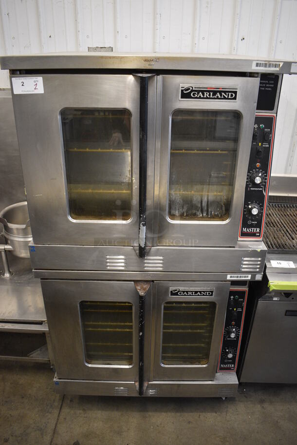 2 Garland Master 200 Stainless Steel Commercial Natural Gas Powered Full Size Convection Oven w/ View Through Doors, Metal Oven Racks and Thermostatic Controls on Commercial Casters. 38x38x70. 2 Times Your Bid!