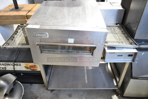Lincoln Impinger 1132-002-U-K1841 Stainless Steel Commercial Floor Style Electric Powered Conveyor Pizza Oven w/ Under Shelf on Commercial Casters. 208 Volts, 3 Phase.