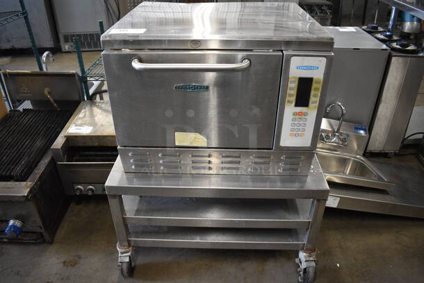 	Turbochef Model NGC Stainless Steel Commercial Electric Powered Rapid Cook Oven on Stainless Steel Equipment Stand w/ Commercial Casters. 208/240 Volts, 1 Phase. 30x30x37
