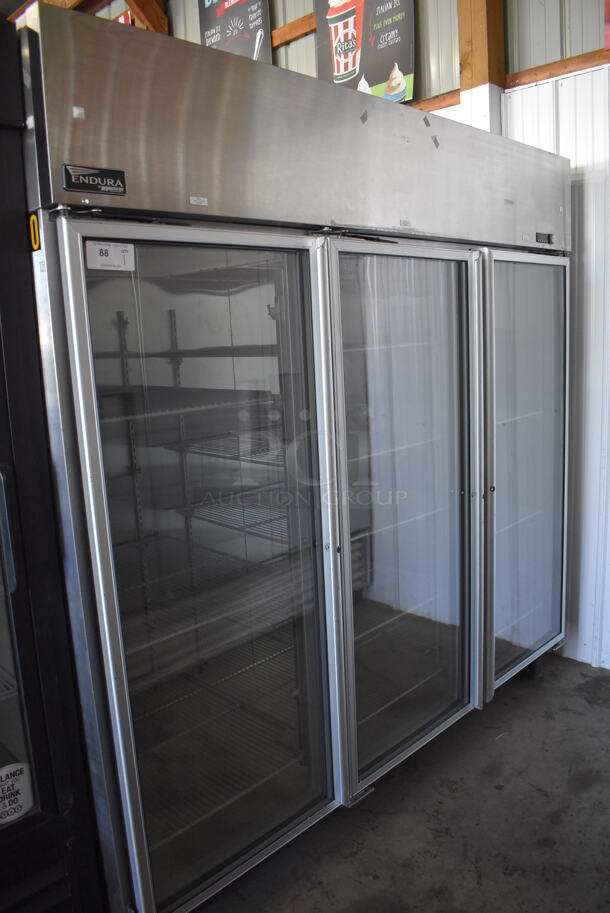 Master-Bilt Endura MNR803SSG/0X Stainless Steel Commercial 3 Door Reach In Cooler Merchandiser w/ Poly Coated Racks on Commercial Casters. 115 Volts, 1 Phase. 82.5x34x82. Tested and Working!