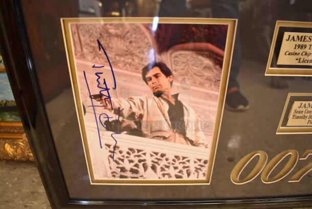 Framed Collage of 5 Autographed James Bonds Actors Including Sean Connery, Roger Moore, Timothy Dalton, Pierce Brosnan, and George Lazenby. Certificate of Authenticity is Attached To Back of Frame. - Image 4 of 9