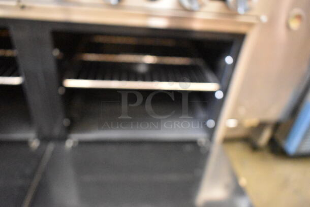 Migali C-RO4-24GL-NG Stainless Steel Commercial Natural Gas Powered 4 Burner Range w/ Flat Top Griddle, 2 Ovens, Over Shelf and Back Splash on Commercial Casters.  - Image 9 of 12