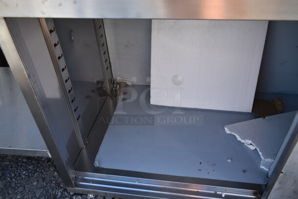 BRAND NEW SCRATCH AND DENT! Regency 600EBTB3072R 30" x 72" 16 Gauge Type 304 Stainless Steel Enclosed Base Sliding Door Table with Drawers and 6" Backsplash - Image 5 of 8