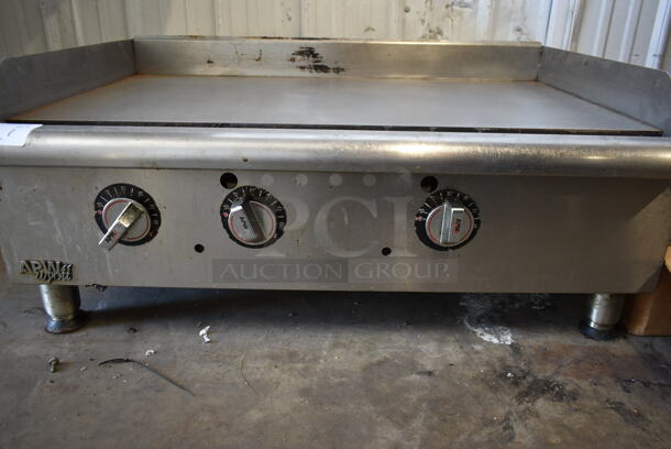 APW Wyott Stainless Steel Commercial Countertop Natural Gas Powered Flat Top Griddle.  - Image 4 of 7