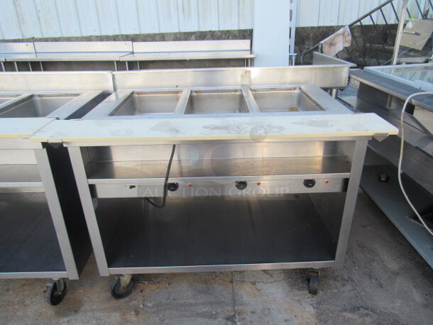 One Delfield 3 Well Electric Steam Table With Under Shelf, And Cutting Board On Casters. 208 Volt. 1 Phase. Model# EHE148C-C. 48X33X37. $5130.00