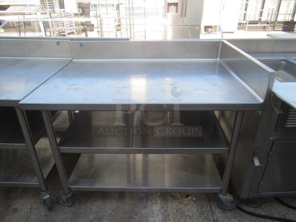 One Stainless Steel Table With 2 Stainless under Shelves, Left Side Splash, And Back Splash On Casters. 60X33X40