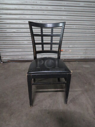 Black Wooden Chair With A Black Cushioned Seat. 4XBID