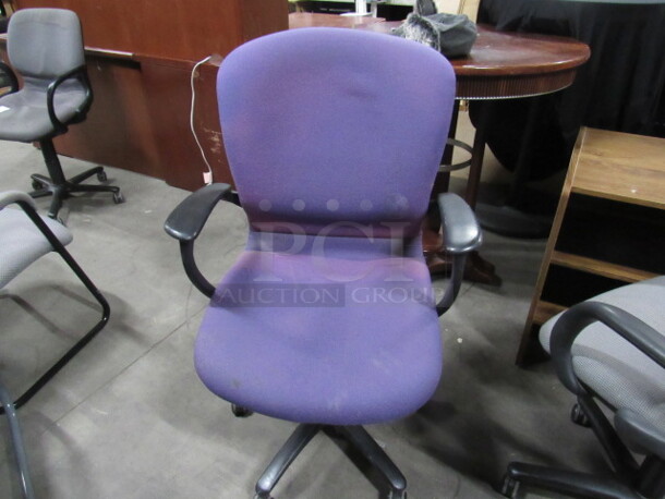 One Purple Cushioned Office Chair On Casters.