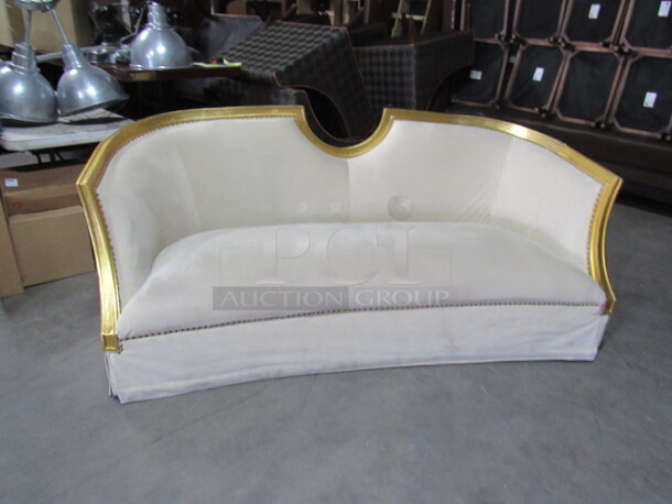 One OverSized Beautiful Couch With Wooden Trim And An Ivory Suede Feel Material With Assorted Pillows. 90X43X36