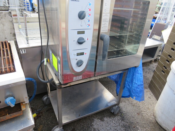 One Rational Combi Master Natural Gas Oven On SS Stand With SS Under Shelf on Casters. Unable To Test. 120 Volt. Model# CM-81G. 34X34X57.5.  - Image 2 of 3