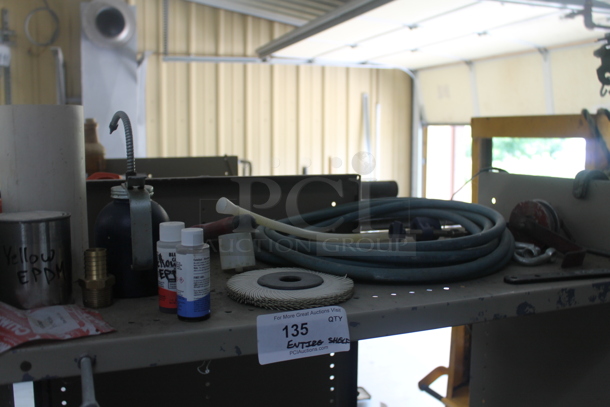 Gray Metal 3 Tier Shelving Unit and Wooden Table w/ Contents Including Iota DLS-27-40 Battery Charger. BUYER MUST REMOVE. - Image 2 of 6