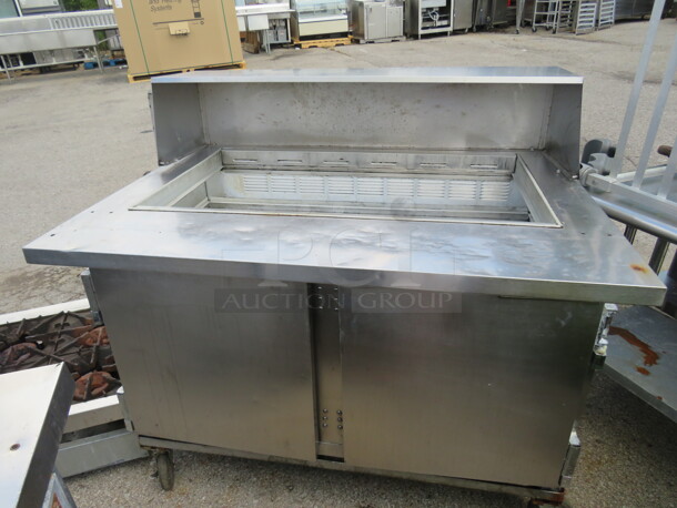 One Beverage Air 2 Door Refrigerated Prep Table On Casters. #SP48-18M. 115 Volt. NEEDS A PLUG. Unable To Test. 48X34X46.