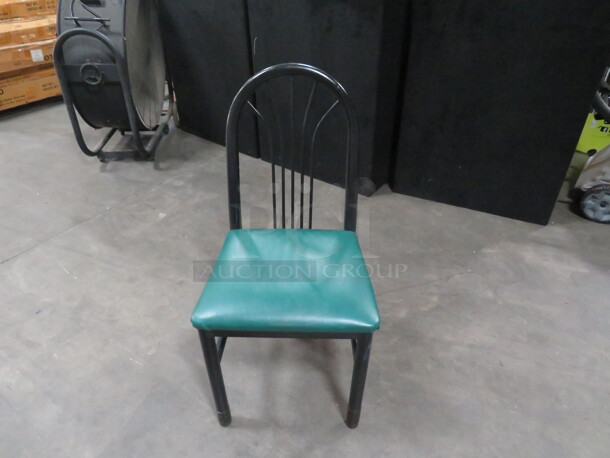 Black Metal Chair With A Green Cushioned Seat. 4XBID