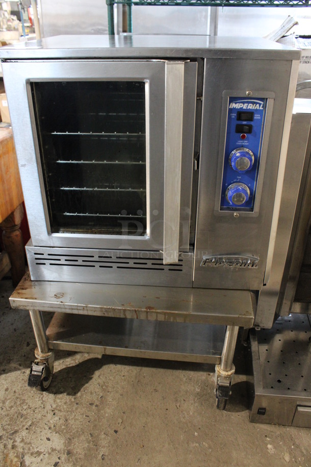 Imperial Stainless Steel Commercial Electric Powered Half Size Convection Oven w/ View Through Door, Metal Oven Racks and Thermostatic Controls. Comes w/ Stainless Steel Commercial Equipment Stand w/ Under Shelf on Commercial Casters. 208 Volts, 3 Phase. 30x27x28, 30x30x17