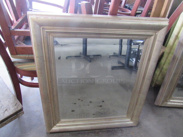 One 28.5X32.5 Framed Mirror.