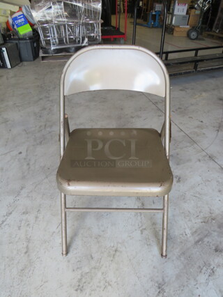 Beige Metal Folding Chair. 11XBID