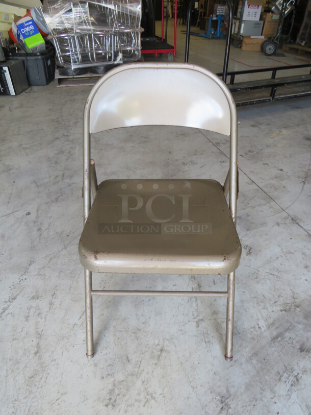Beige Metal Folding Chair. 11XBID - Item #1110975