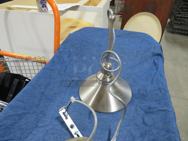 One Stainless Steel 8 Inch Pendant Barn Lite.  - Image 1 of 1