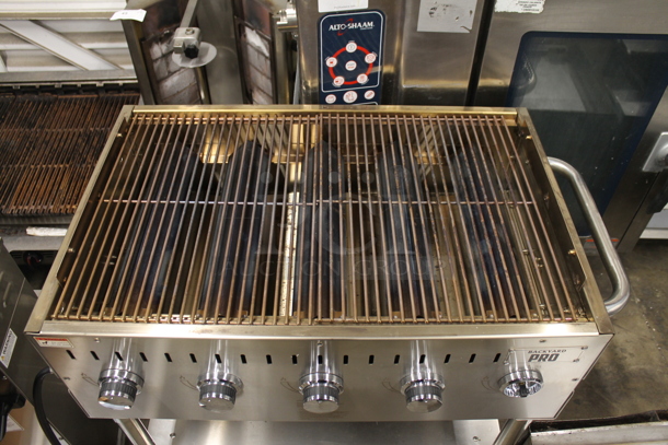 LIKE NEW! 2022 Backyard Pro 554LPG36 Stainless Steel Commercial Propane Gas Powered Outdoor Grill w/ Brick Oven Attachment and Under Shelf on Commercial Casters. Stock Picture Used as Gallery. Tested and Working! - Image 6 of 7