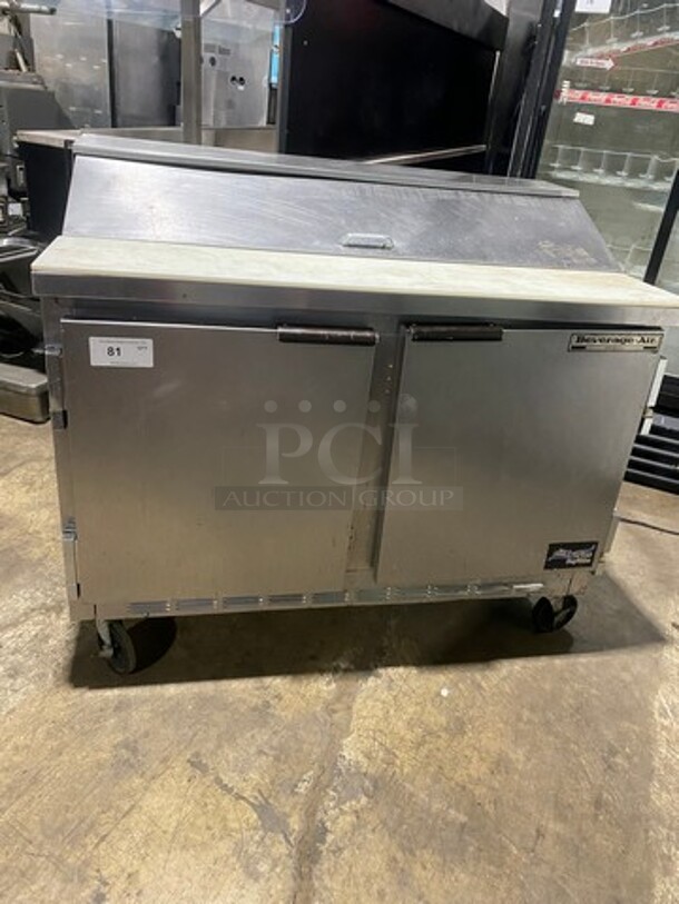 Nice! Beverage Air Commercial Refrigerated Sandwich Prep Table! With Commercial Cutting Board! With 2 Door Underneath Storage Space! With Poly Coated Racks! All Stainless Steel! On Casters! Model: SPE4812 115V 60HZ 1 Phase! Working When Removed!