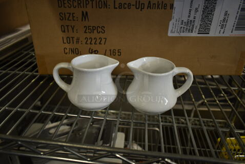 Box of White Ceramic Cream Pitchers.