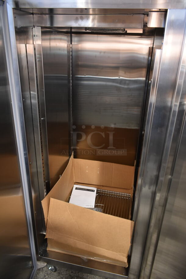 BRAND NEW SCRATCH AND DENT! 2022 Delfield GAHPT2-S Stainless Steel Commercial 2 Door Reach In Pass Through Warmer w/ Poly Coated Racks on Commercial Casters. 115 Volts, 1 Phase.  - Image 5 of 9