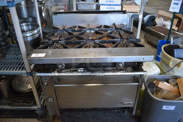 Jade Stainless Steel Commercial Natural Gas Powered 6 Burner Range w/ Oven and Backsplash. Leg Needs To Be Reattached. 36x38x42