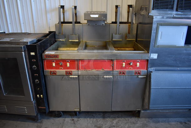 Vulcan 30RD45 Stainless Steel Commercial Floor Style Natural Gas Powered 2 Bay Deep Fat Fryer w/ Center Dumping Station on Commercial Casters. Missing Caster. 240,000 BTU. 47x35x58
