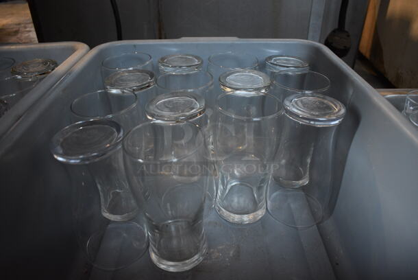 34 Beverage Glasses in 2 Gray Poly Bus Bins. 3x3x6. 34 Times Your Bid!