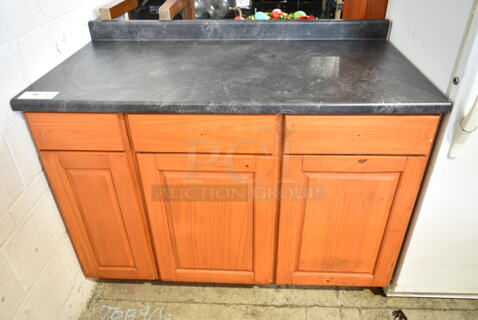 Black Counter w/ Back Splash and 3 Doors. 