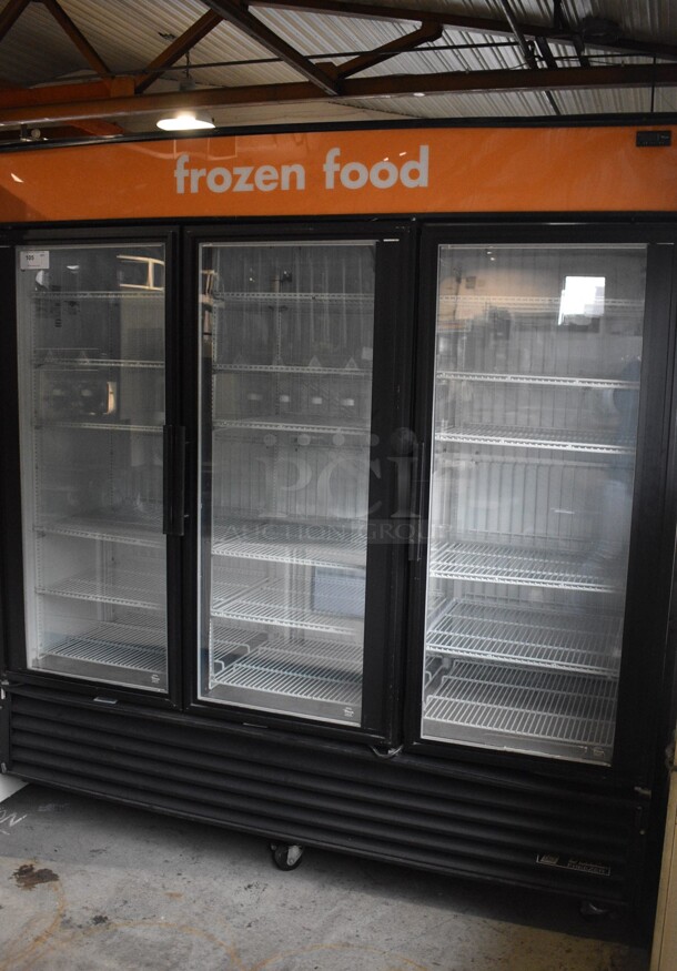 2012 True Model GDM-72F Metal Commercial 3 Door Reach In Freezer Merchandiser w/ Poly Coated Racks on Commercial Casters. 115/208-230 Volts, 1 Phase. 79x30x82