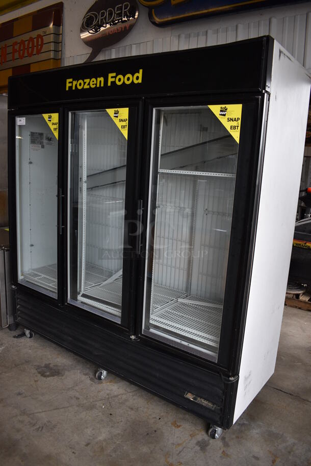 2010 True Model GDM-72F Metal Commercial 3 Door Freezer Merchandiser w/ Poly Coated Racks on Commercial Casters. 115/208-230 Volts, 1 Phase. 78x30x79