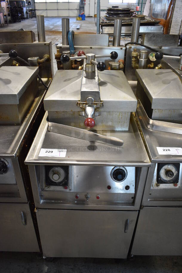 Henny Penny Model 600 Stainless Steel Commercial Floor Style Natural Gas Powered Pressure Fryer w/ Fry Basket on Commercial Casters. 18x39x50