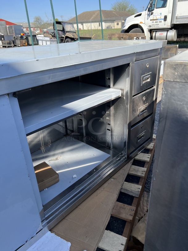 BRAND NEW SCRATCH AND DENT! Regency 600EBT2472R Stainless Steel Commercial 24" x 72" 16 Gauge Type 304 Enclosed Base Sliding Door Table with Drawers - Image 4 of 10
