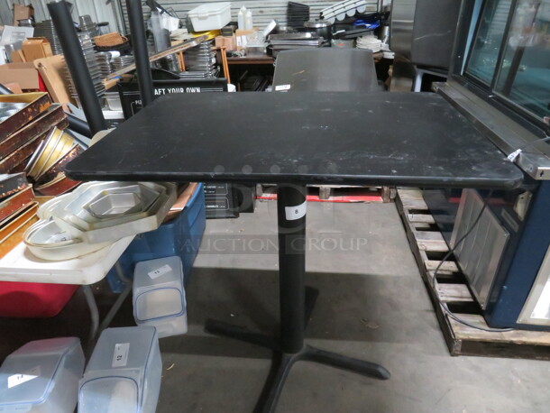 One Black Laminate Table Top On A Pedestal Base. 42X30X41