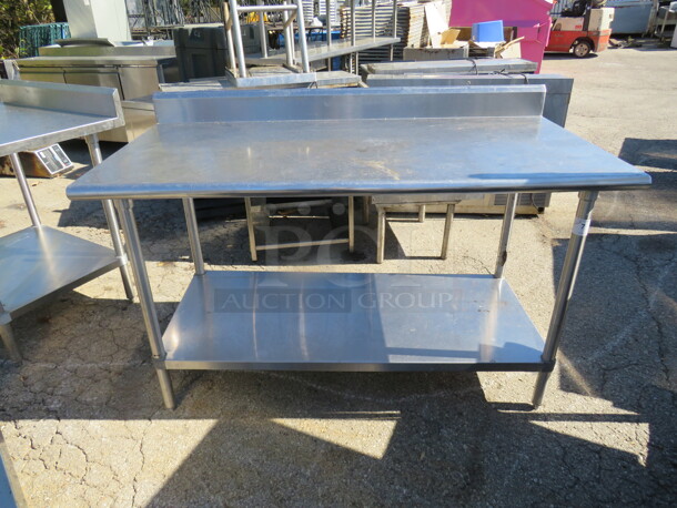 One Stainless Steel Table With Back Splash And SS Under Shelf. 60X30X40 - Image 1 of 1