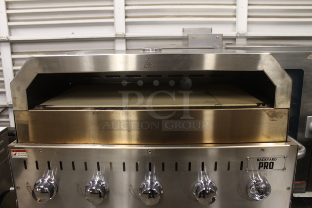 LIKE NEW! 2022 Backyard Pro 554LPG36 Stainless Steel Commercial Propane Gas Powered Outdoor Grill w/ Brick Oven Attachment and Under Shelf on Commercial Casters. Stock Picture Used as Gallery. Tested and Working! - Image 3 of 7