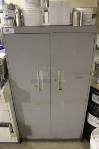 Gray Metal 2 Door Cabinet w/ Contents. Unit Is Locked. Does Not Come w/ Key. 