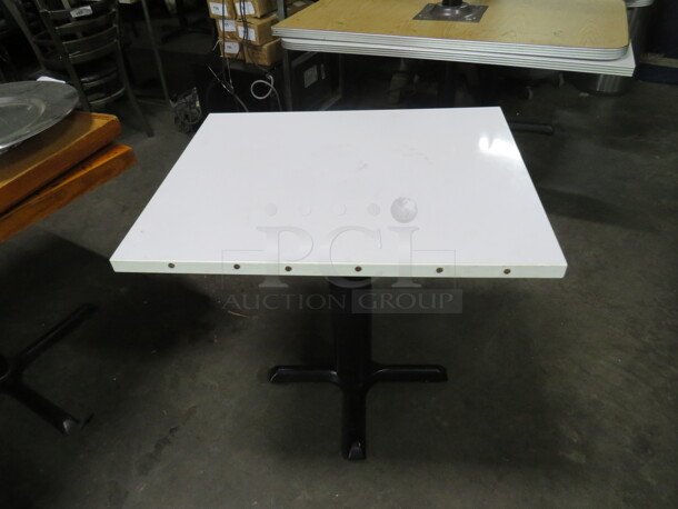 One White Laminate Table Top On A Pedestal Base. 24X30X30