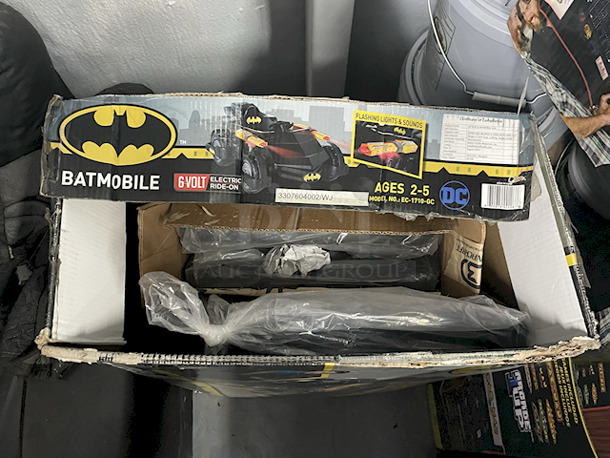 NEW/NEVER USED - DC Batmobile Car, Model: EC-1710-GC – Authentic Batman Design6v Electric Ride-On ; Forward & Reverse Drive; Flashing Blasters; Engine Starting Sound; (5) Unique Sounds: Fire Blasters – Start Up – Afterburner – Shield – Night Vision. Top of box is open, all parts appear to be in the box in original packaging.  - Image 3 of 3