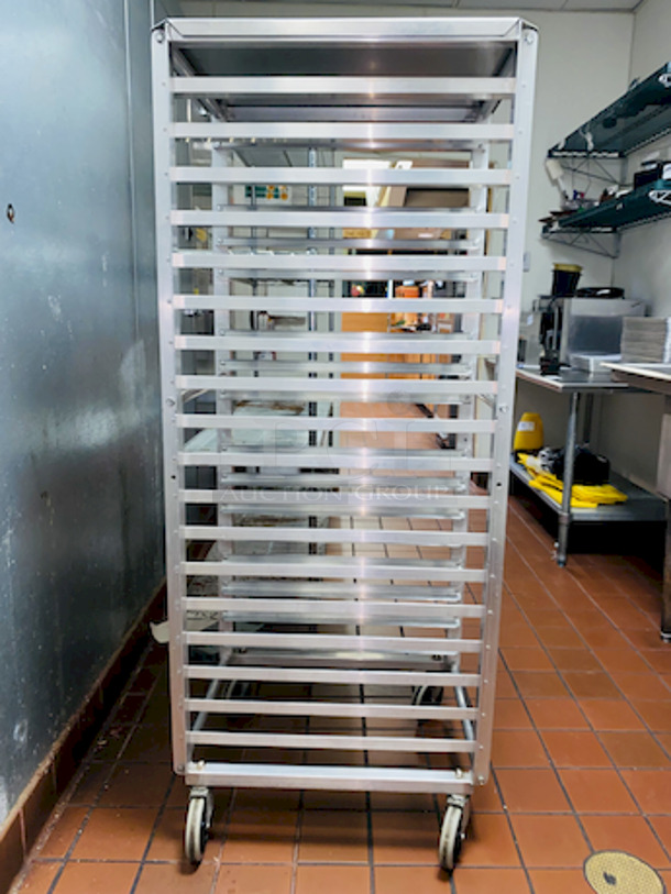 ALMOST PERFECT! Lockwood RA64-ER18ES Intermediate Height 18 Level 64" End Load Rack.
Condition: 8/10 
A hard working, versatile line of racks
Construction: High tensile extruded aluminum
Dimensions: 64"H x 21 3/8"W x 26 1/2"D
Tray supports: 1-1/2″ wide extruded pan supports riveted to uprights
Center Spacing: 3"
Pan Capacity: (18) 18" x 26" pans
Casters: 5" non-marking swivel threaded stem
Actual Weight: 45 lbs. - Image 2 of 6