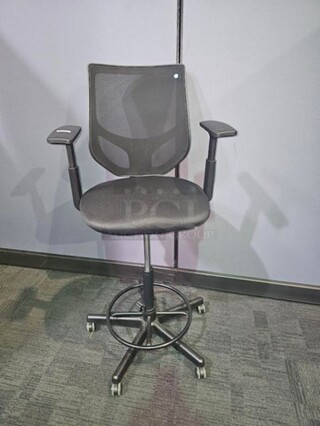 Tall black desk chair on wheels made by Henglin Home Furnishings Co. LTD. Features armrests and is adjustable height. In good used conditions- minor signs of wear. No rips, holes or broken pieces. Measures 52” H x 25” W.  

