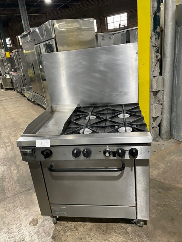 Amazing! Southbend Heavy Duty Commercial Natural Gas Powered 4 Burner Stove! With Left Sidle Flat Griddle! With Raised Back Splash! With Oven Underneath! All Stainless Steel! On Casters! Model P32DBBB! Working When Removed! - Image 1 of 9