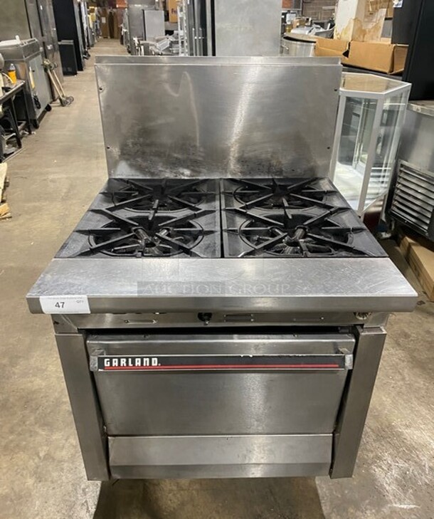 Garland Commercial Natural Gas Powered 4 Burner Stove! With Oven Underneath! With Raised Backsplash! All Stainless Steel! Model M44R - Item #1113625